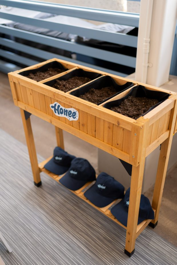 The Honee planter box filled with soil and branded caps
