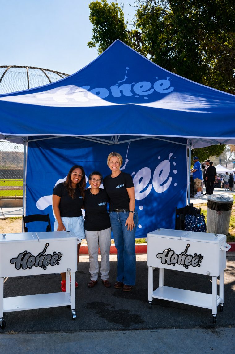 Three team members in Honee tees under the Honee pop up tent