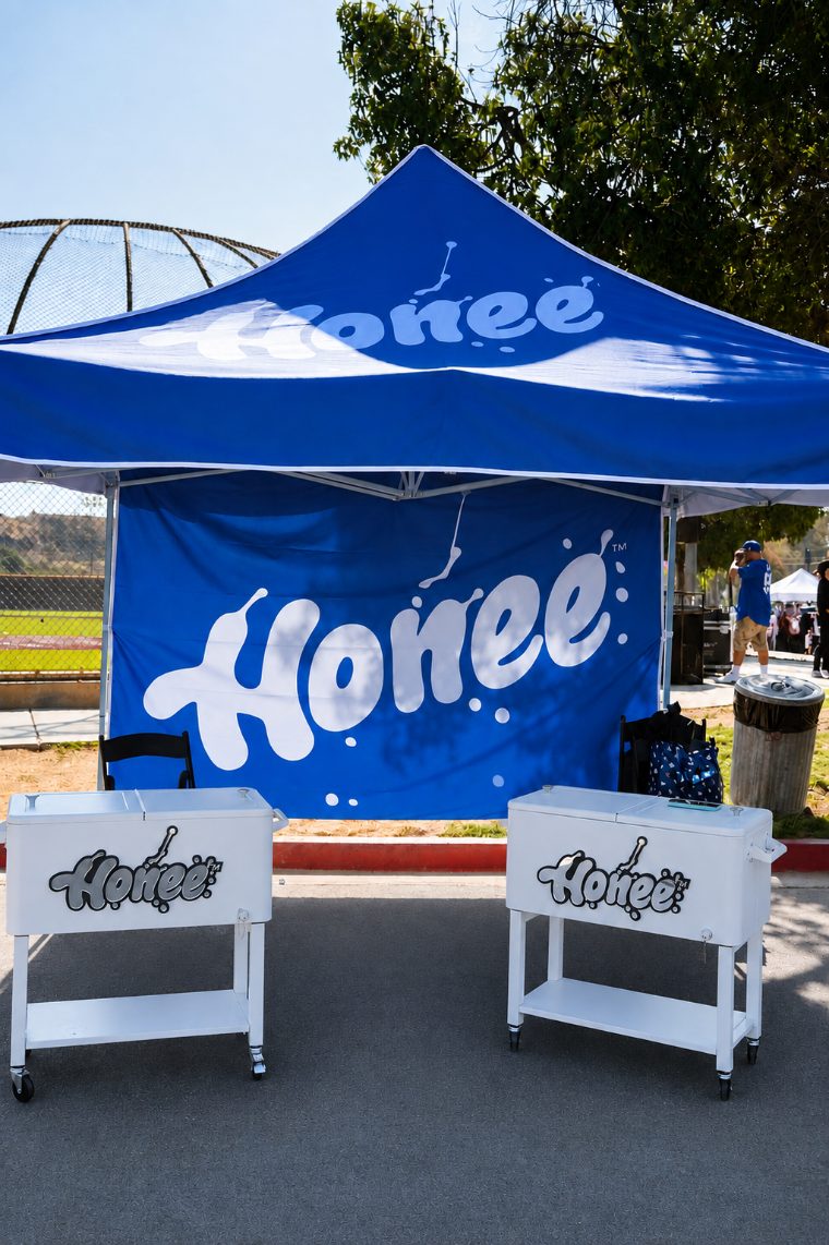 The Honee pop up tent with two branded coolers