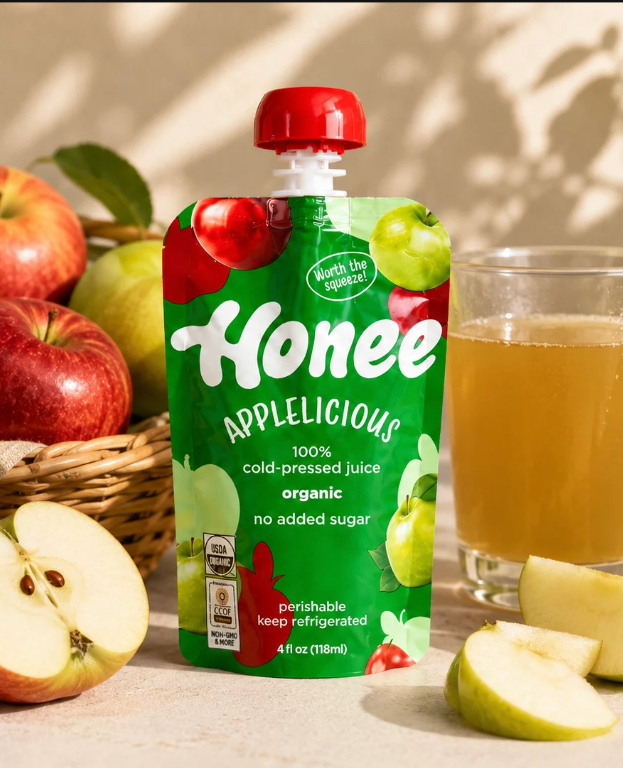Honee Applelicious pouch with fresh fruit and a glass of juice